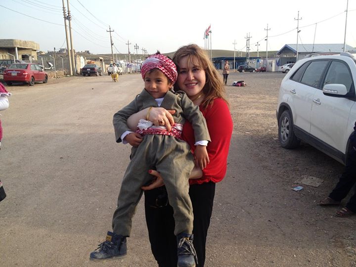 KHRW Director, Pary, with a boy in Iraqi Kurdistan